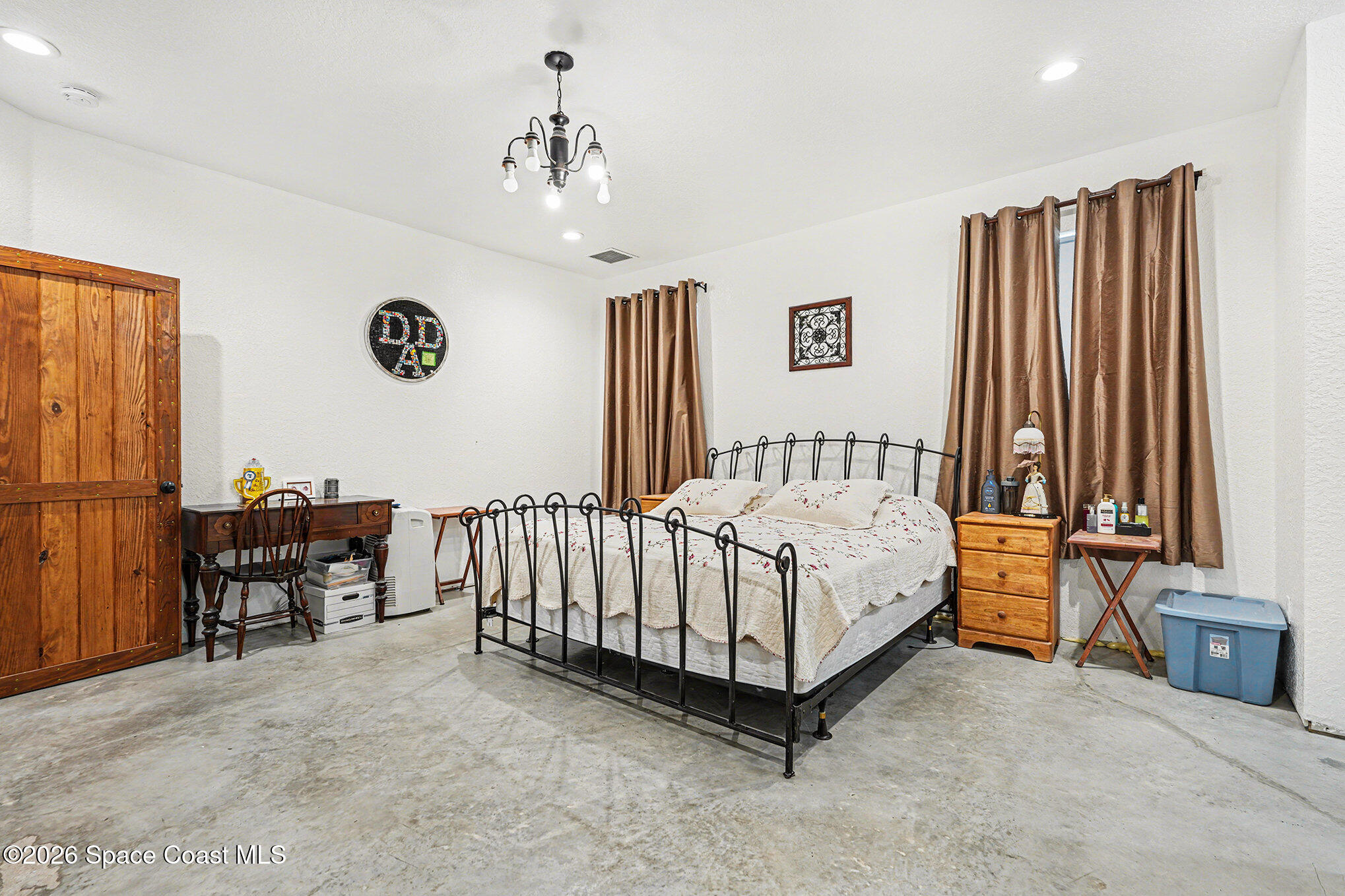 4960 Dixie Way Mims, FL 32754 - Photo 15 of 29 a spacious bedroom with a bed and a table