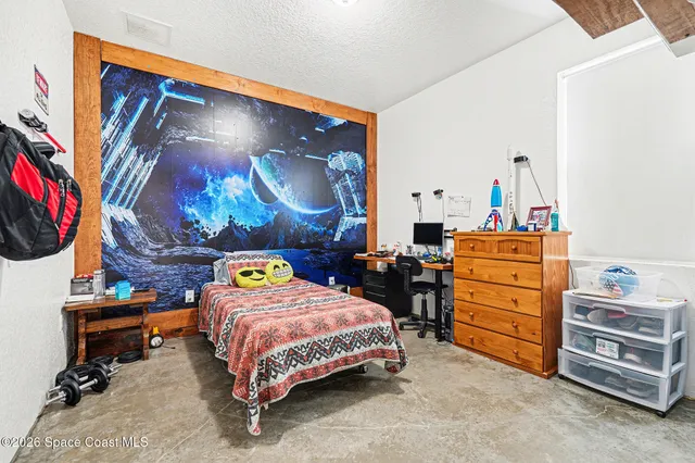 a bedroom with a bed and dresser