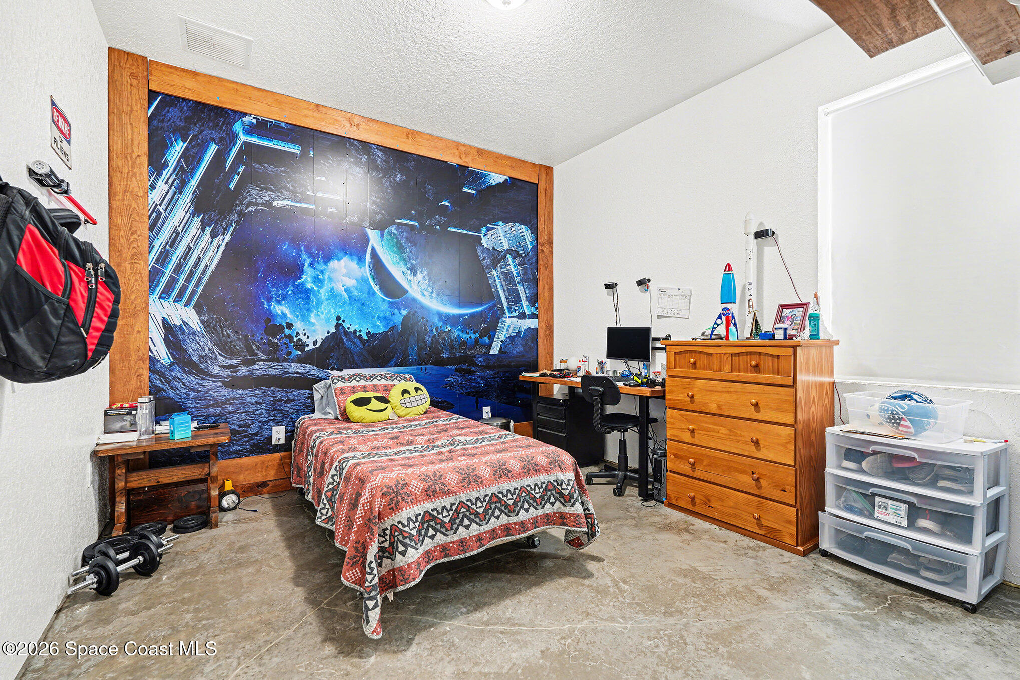 4960 Dixie Way Mims, FL 32754 - Photo 16 of 29 a bedroom with a bed and dresser