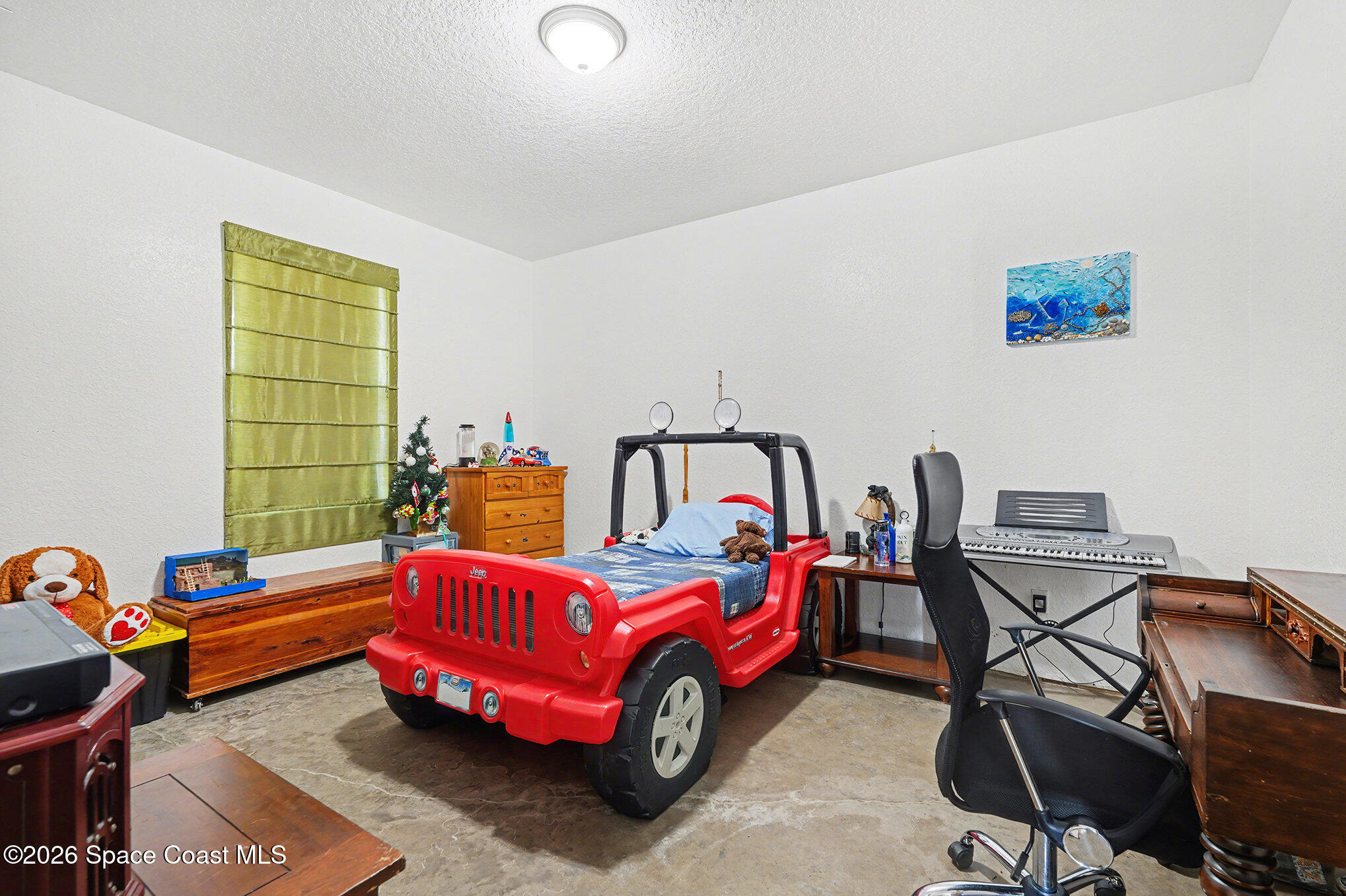 4960 Dixie Way Mims, FL 32754 - Photo 17 of 29 a bedroom with a bed and a chandelier