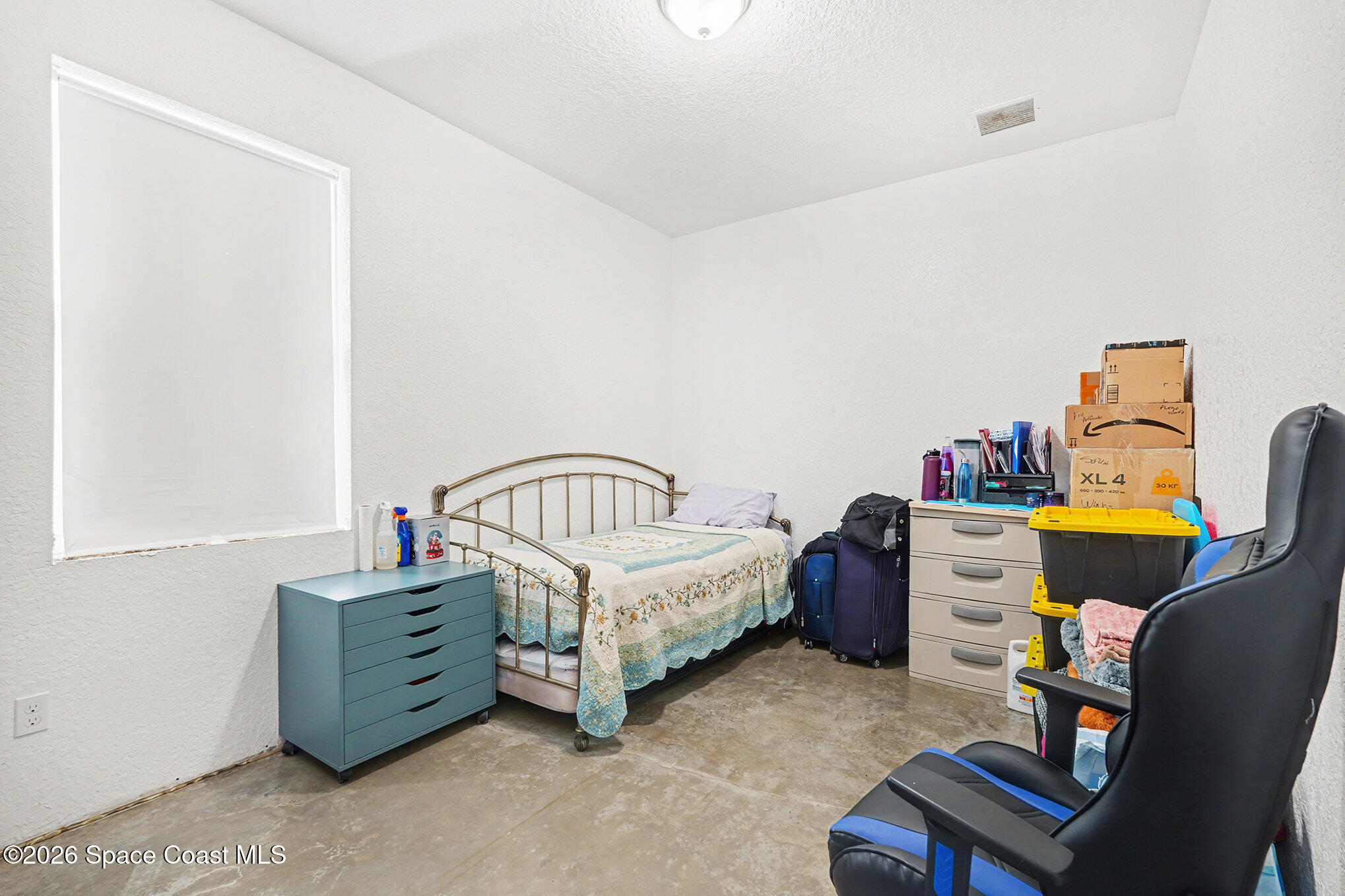 4960 Dixie Way Mims, FL 32754 - Photo 18 of 29 a bedroom with a bed and a window