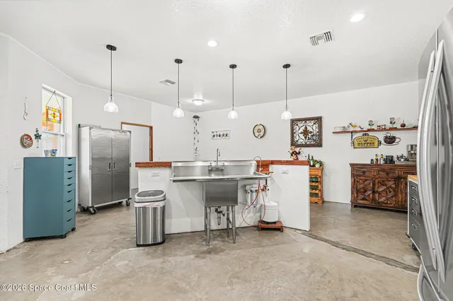 a view of kitchen and refrigerator