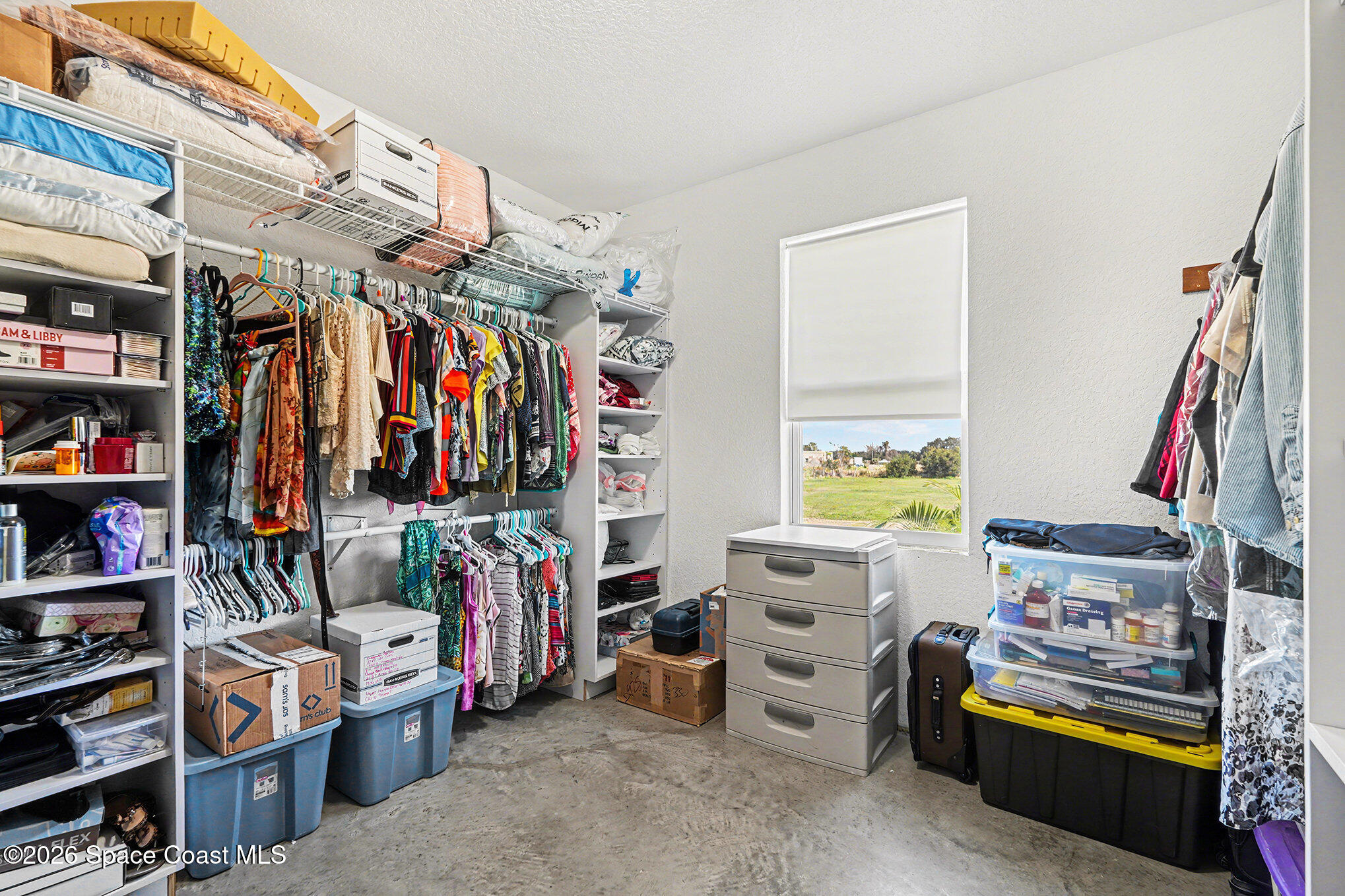 4960 Dixie Way Mims, FL 32754 - Photo 26 of 29 a view of walk in closet with clothes and shoes