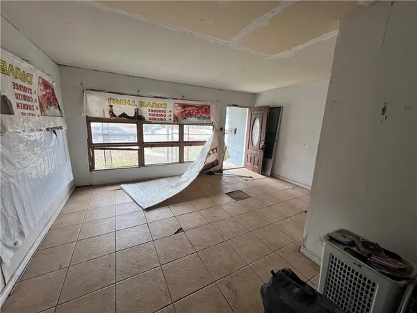 a large bedroom with a bed and window