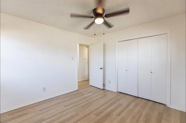 a view of an empty room with a fan