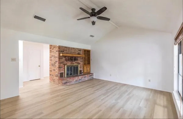 wooden floor in an empty room with a window