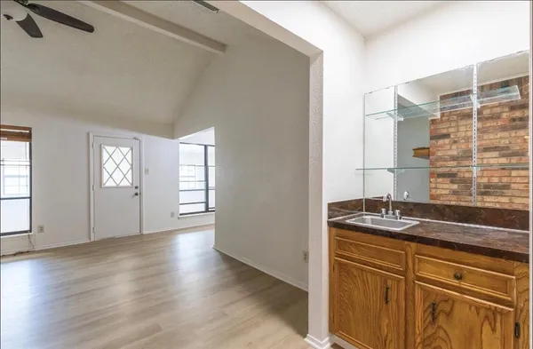 a kitchen with granite countertop a sink and a stove top oven