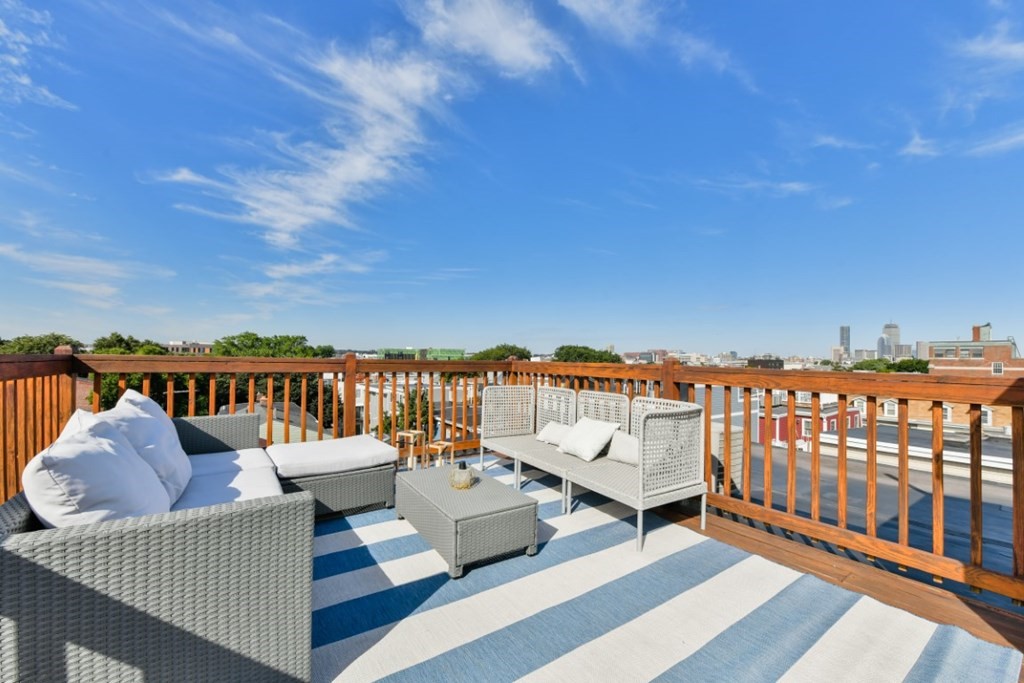 a view of a balcony with wooden benches