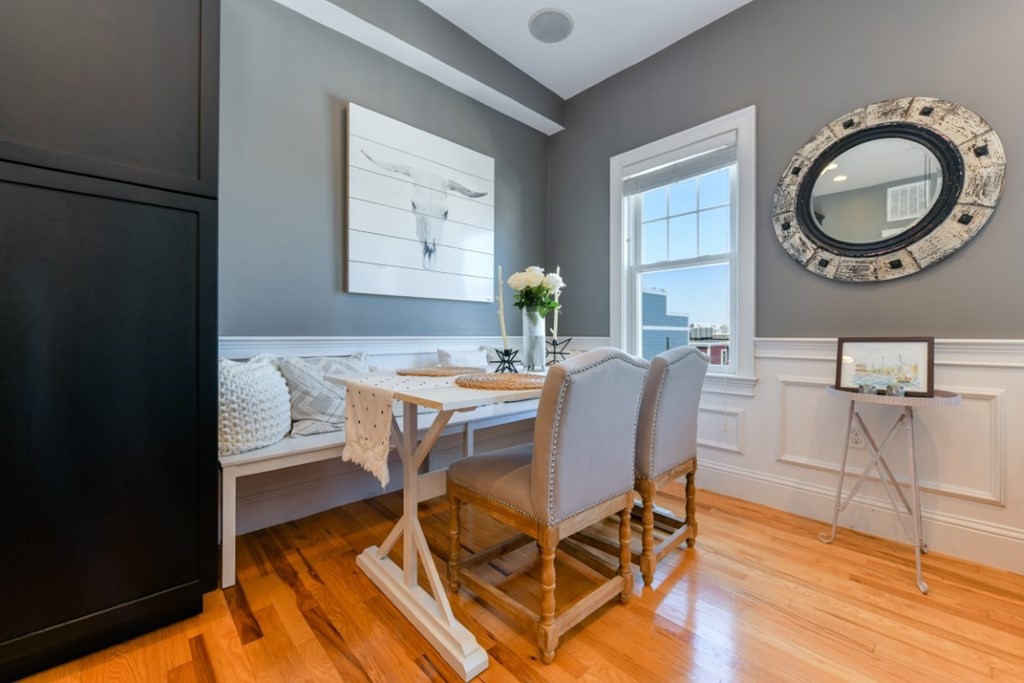 5 Grimes Street, Unit 3 Boston, MA 02127 - Photo 11 of 16 a dining room with wooden floor a glass table and chairs