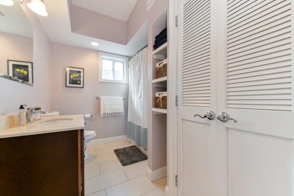 5 Grimes Street, Unit 3 Boston, MA 02127 - Photo 15 of 16 a bathroom with a sink and a mirror
