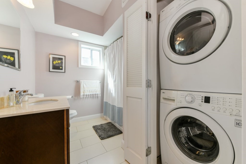 5 Grimes Street, Unit 3 Boston, MA 02127 - Photo 16 of 16 a view of a hallway with washer and dryer