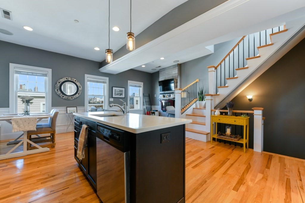 5 Grimes Street, Unit 3 Boston, MA 02127 - Photo 3 of 16 a kitchen with stainless steel appliances granite countertop a kitchen island a stove and a wooden floors