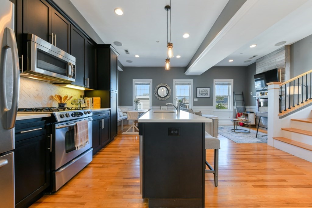 5 Grimes Street, Unit 3 Boston, MA 02127 - Photo 4 of 16 a kitchen with stainless steel appliances granite countertop a sink a stove top oven a counter space and cabinets