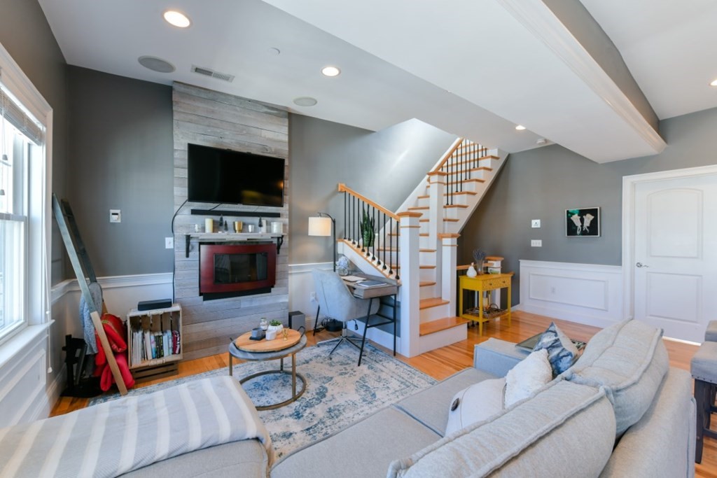 5 Grimes Street, Unit 3 Boston, MA 02127 - Photo 6 of 16 a living room with furniture and a flat screen tv