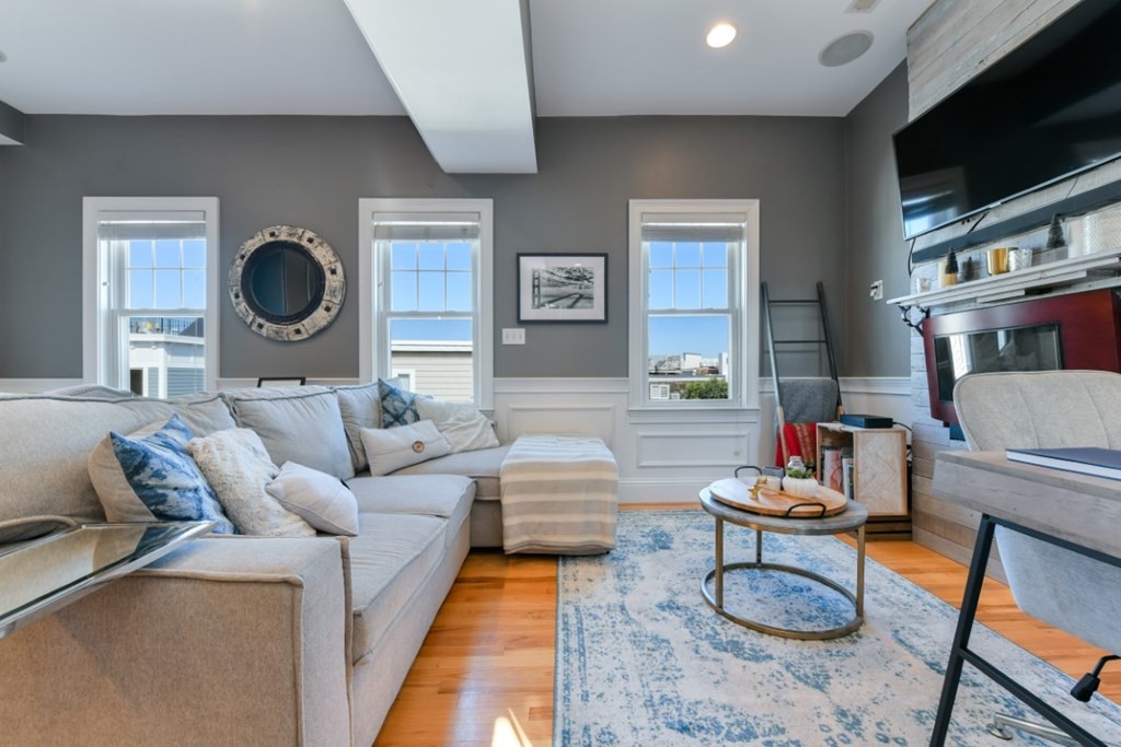 5 Grimes Street, Unit 3 Boston, MA 02127 - Photo 7 of 16 a living room with furniture and a flat screen tv