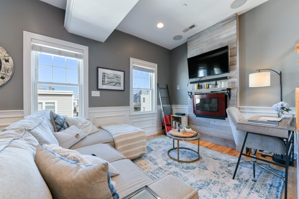 5 Grimes Street, Unit 3 Boston, MA 02127 - Photo 8 of 16 a living room with furniture and a flat screen tv