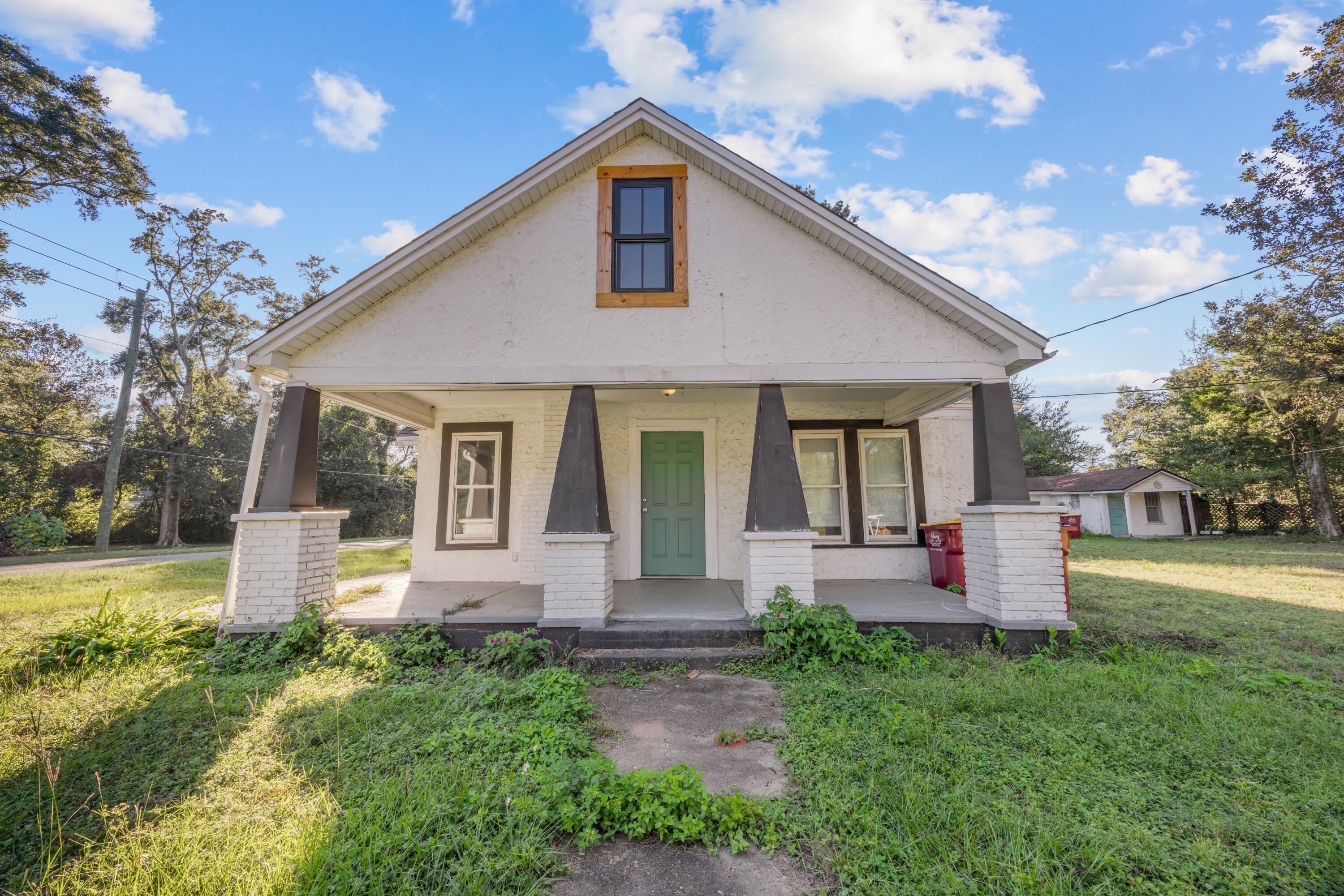 a front view of house with yard and outdoor seating