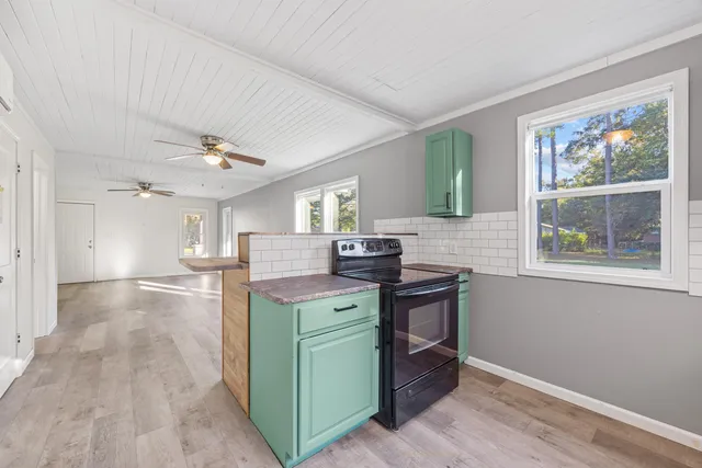 a kitchen with stainless steel appliances granite countertop a sink and a refrigerator