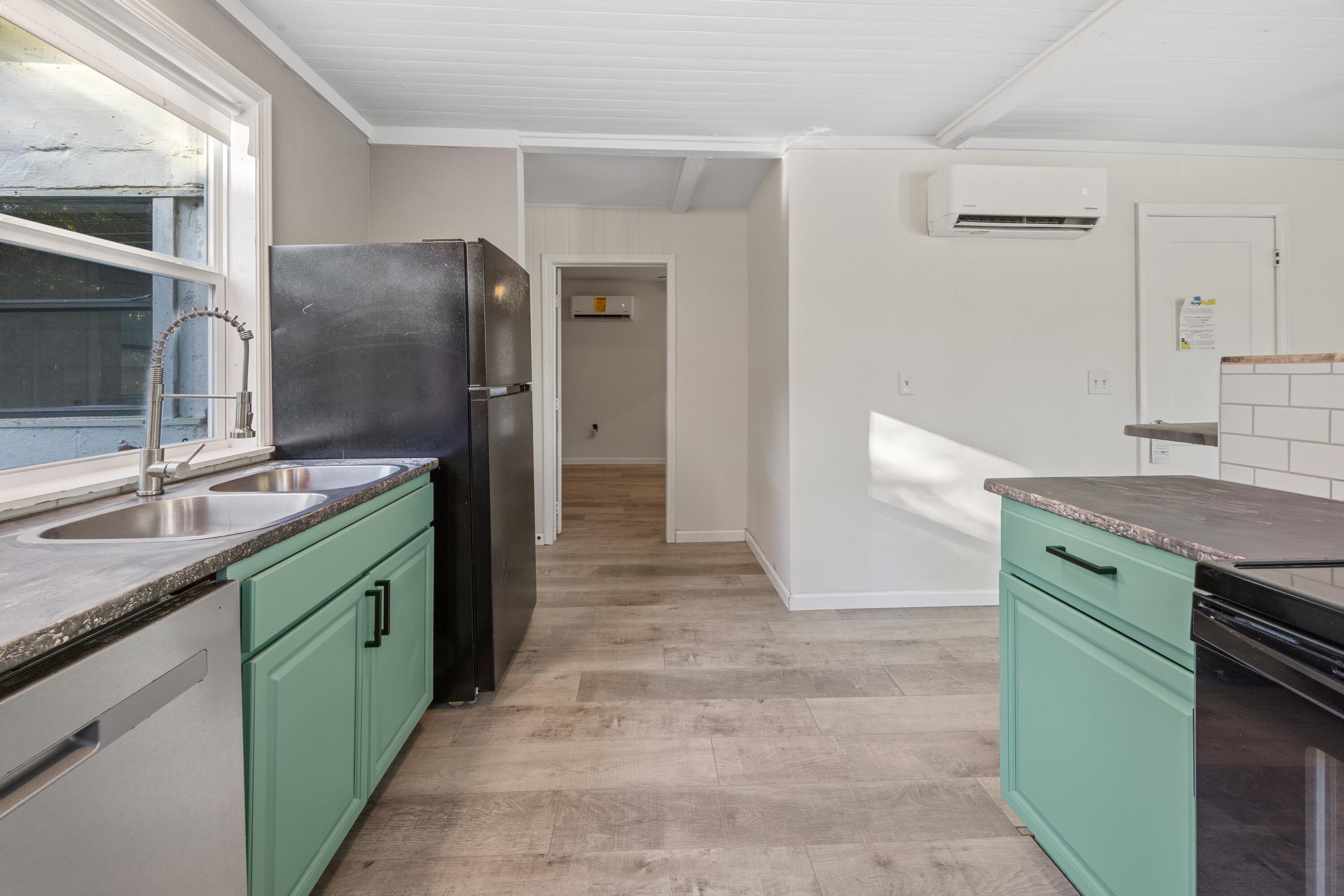 198 East 1st Avenue Crestview, FL 32536 - Photo 13 of 43 a kitchen with stainless steel appliances granite countertop a sink and a refrigerator