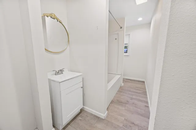 a white toilet sitting next to a white wall
