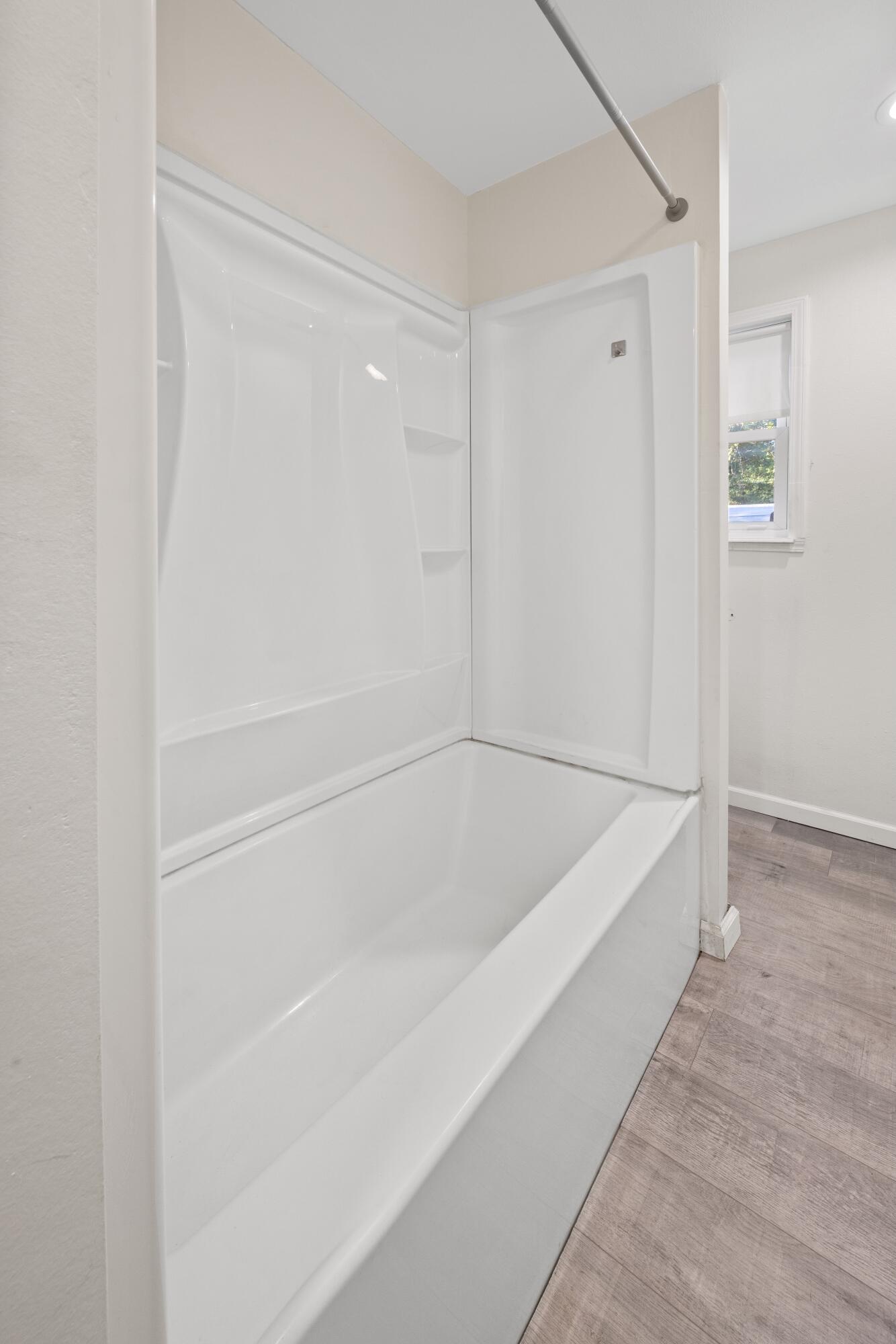 198 East 1st Avenue Crestview, FL 32536 - Photo 17 of 43 a white bath tub sitting next to a shower