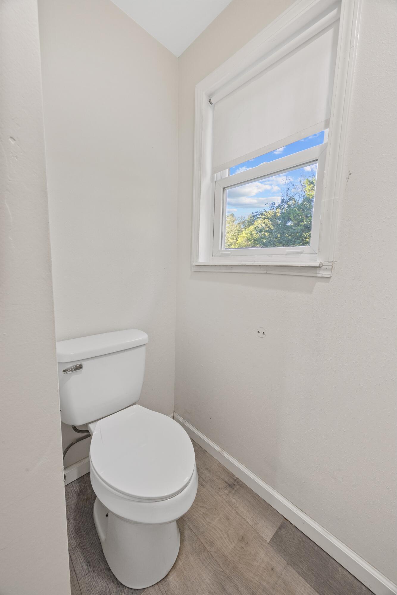 198 East 1st Avenue Crestview, FL 32536 - Photo 18 of 43 a white toilet sitting next to a white wall