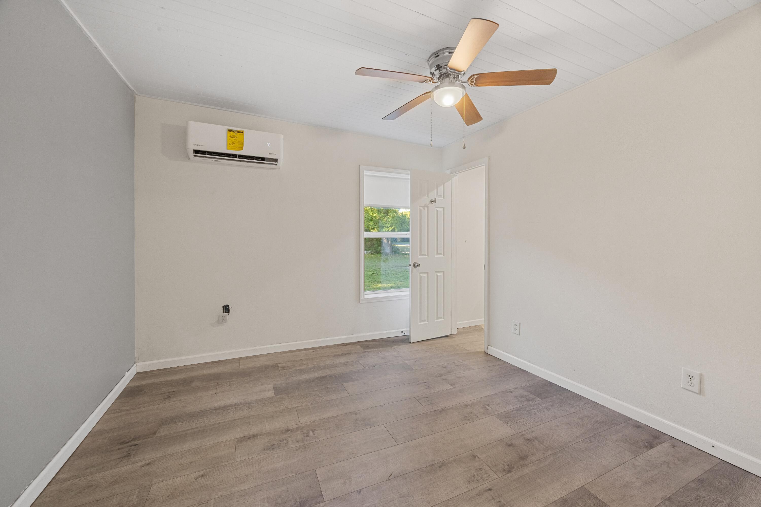 198 East 1st Avenue Crestview, FL 32536 - Photo 19 of 43 an empty room with a window and a ceiling fan