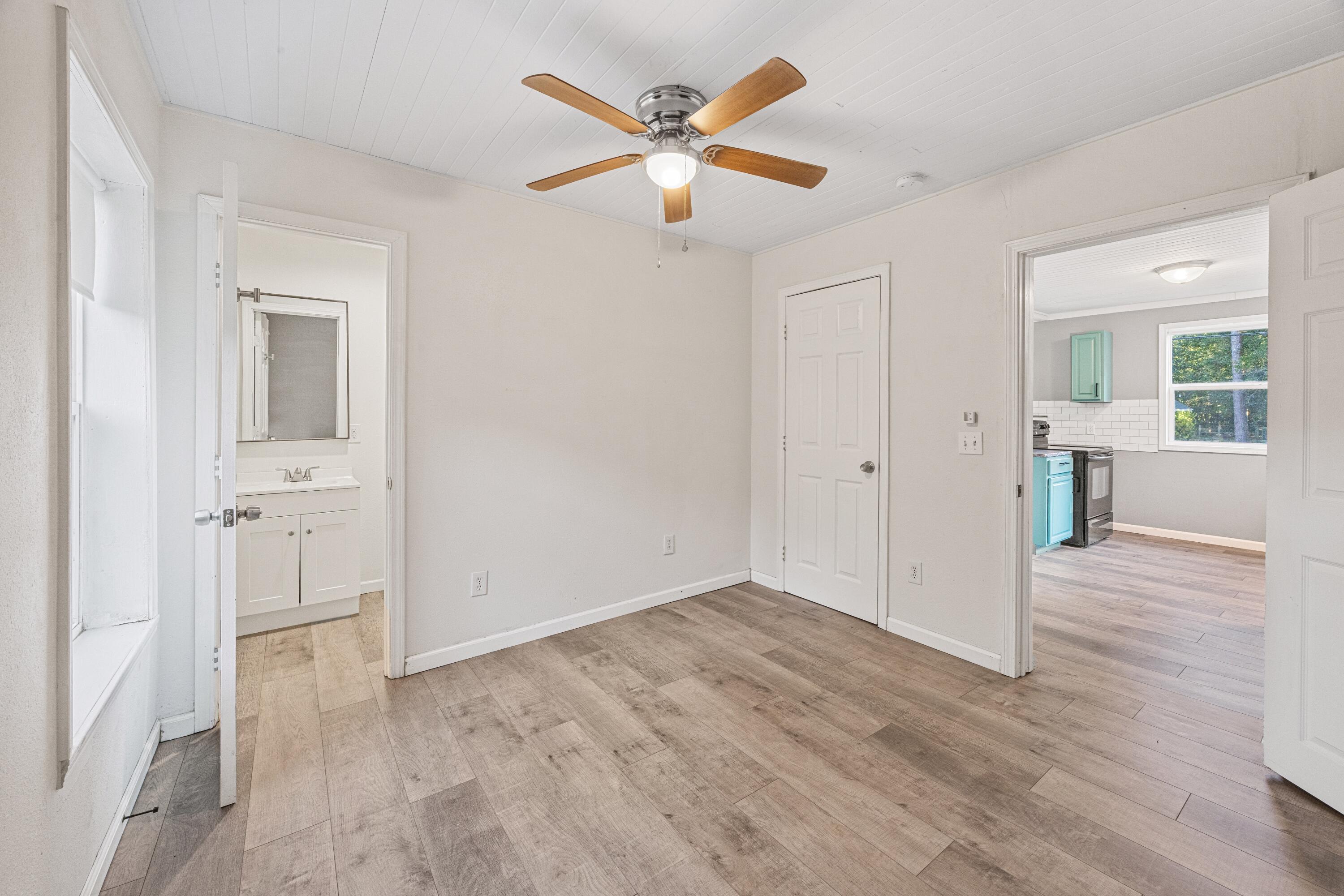198 East 1st Avenue Crestview, FL 32536 - Photo 20 of 43 wooden floor in an empty room with a window