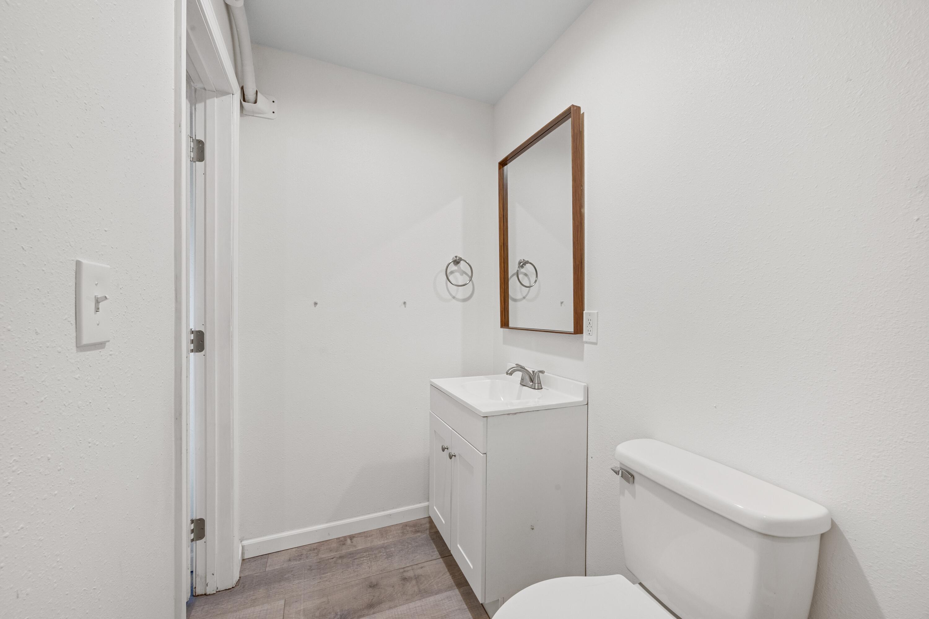 198 East 1st Avenue Crestview, FL 32536 - Photo 22 of 43 a white toilet sitting next to a bathroom sink