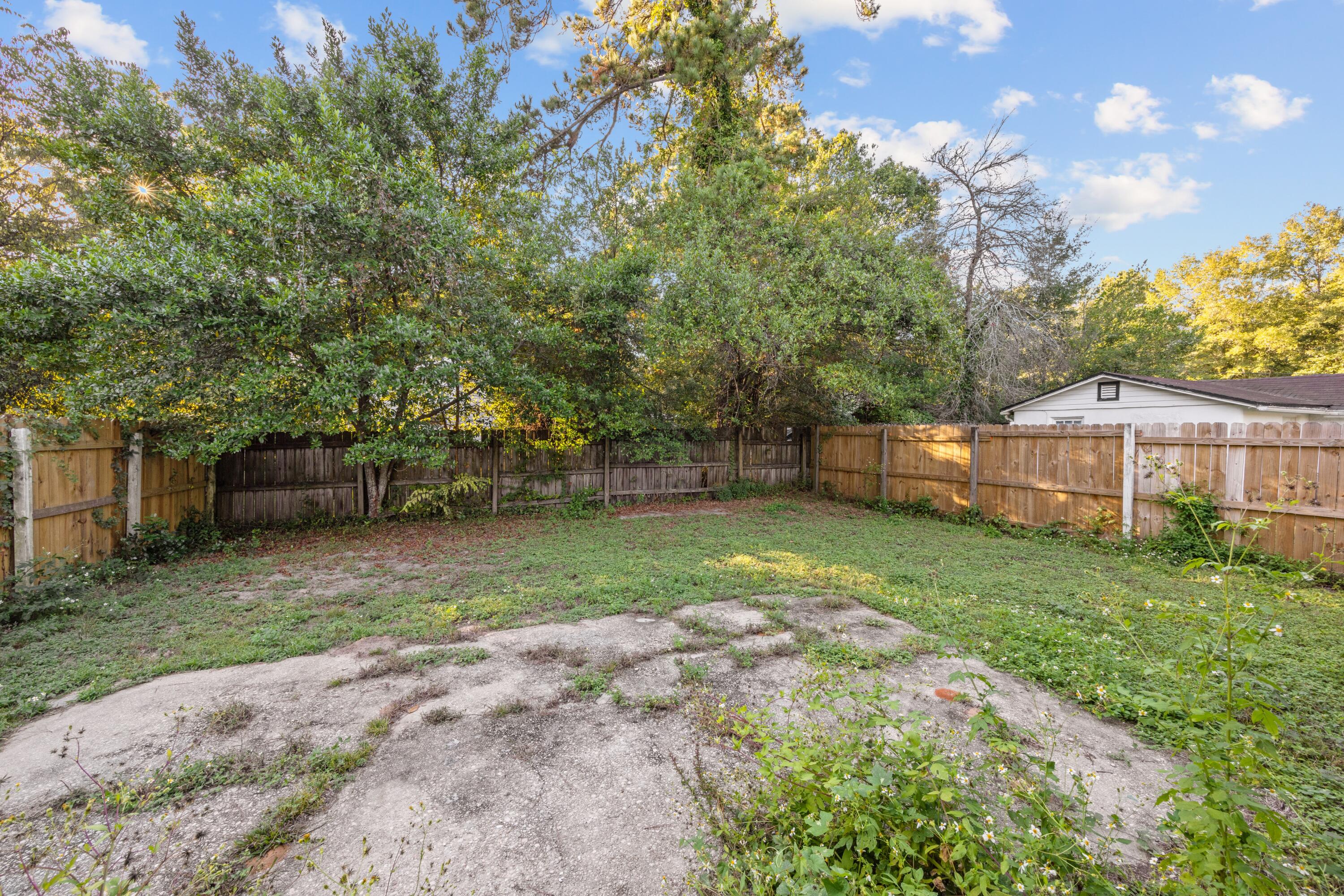 198 East 1st Avenue Crestview, FL 32536 - Photo 25 of 43 a view of a backyard with plants and large trees