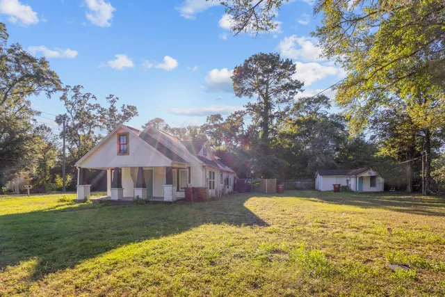 a view of a house with swimming pool next to a yard