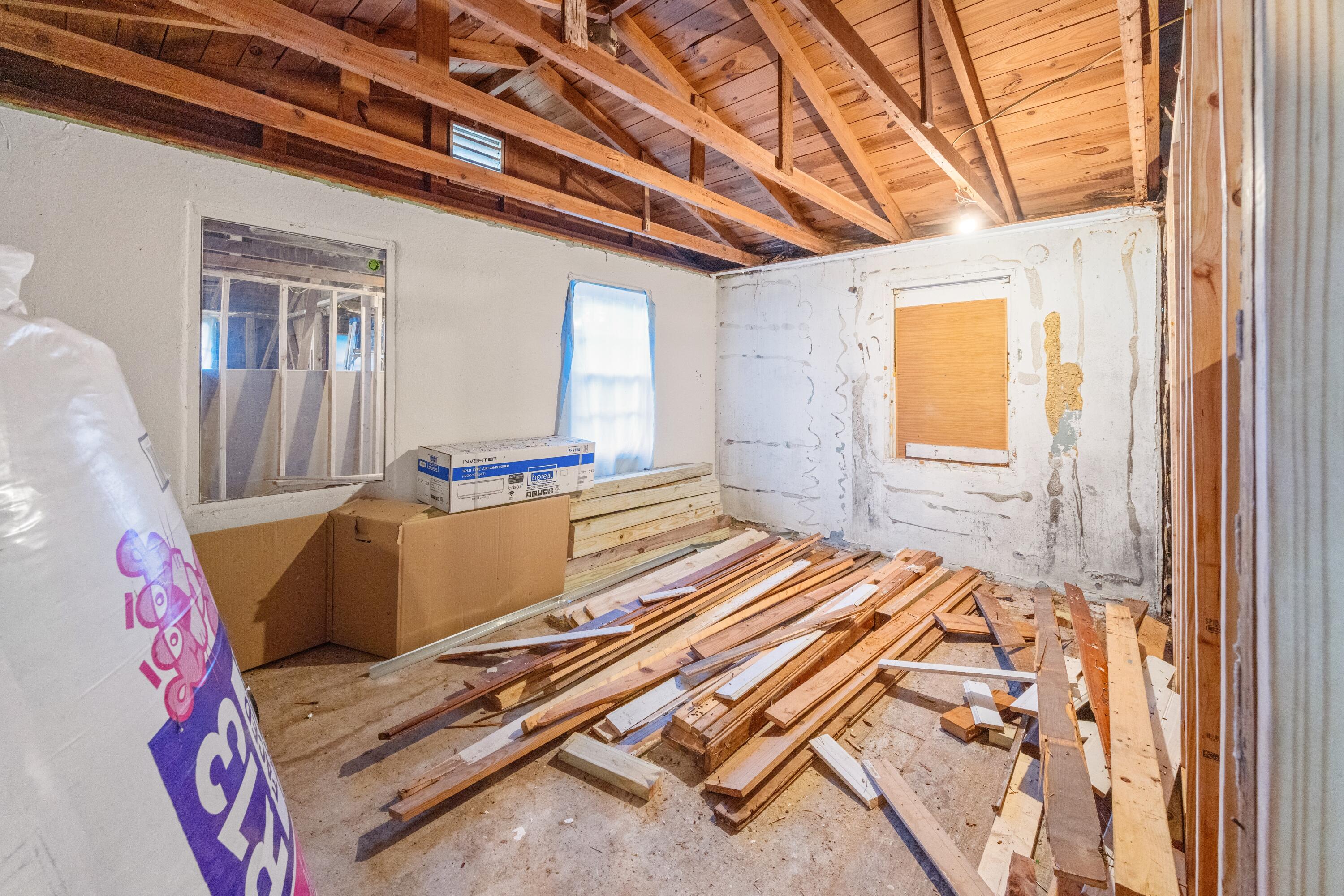 198 East 1st Avenue Crestview, FL 32536 - Photo 42 of 43 a bedroom with a bed and wooden floor