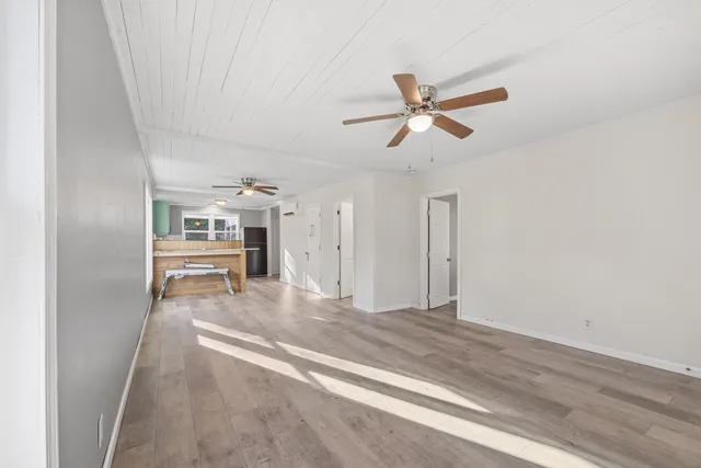 a living room with furniture and a ceiling fan