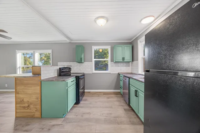 a kitchen with a refrigerator and a sink