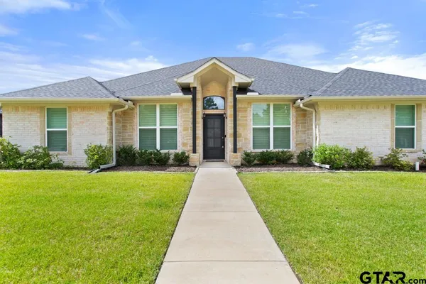 a kitchen with stainless steel appliances granite countertop a sink a stove and a wooden floors