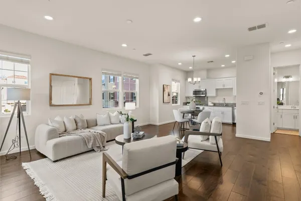 a living room with furniture and kitchen view