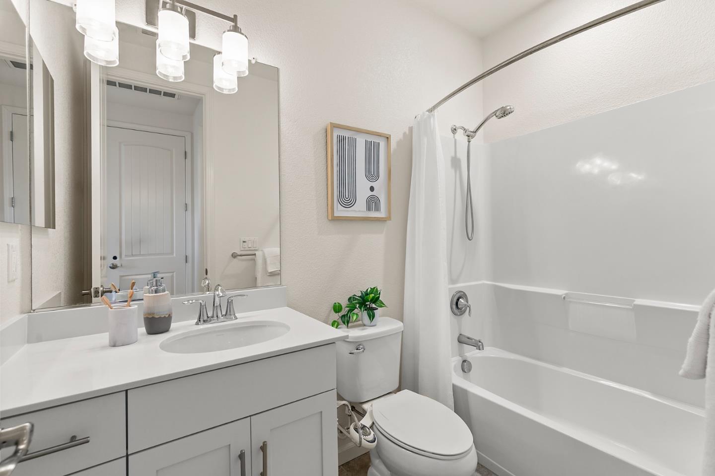 39829 Pelton Terrace Newark, CA 94560 - Photo 18 of 20 a bathroom with a sink toilet a large mirror and shower