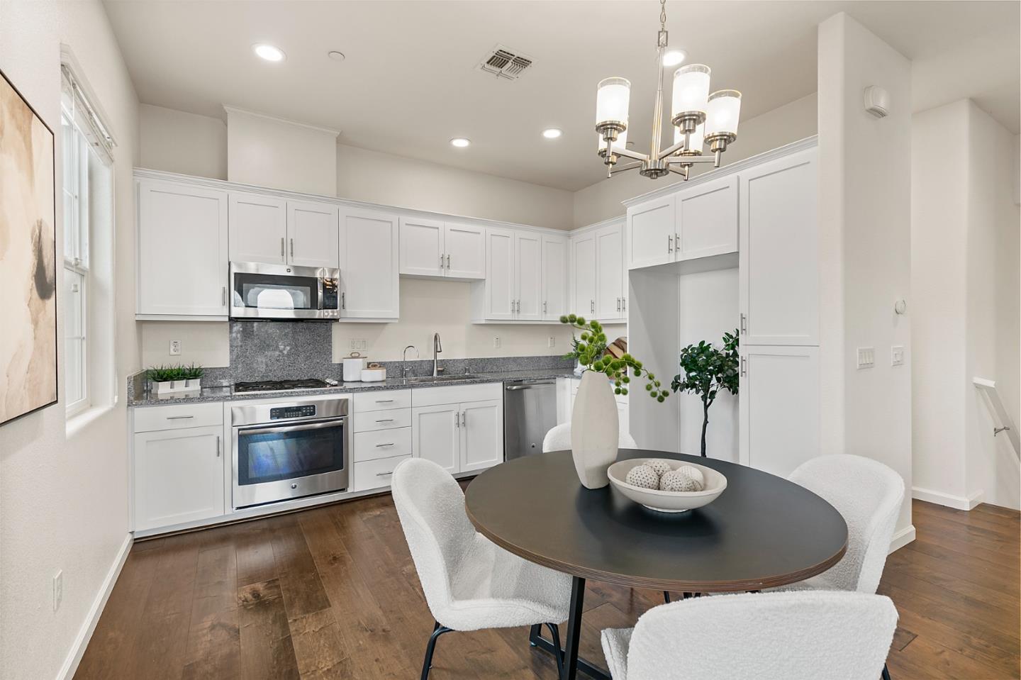 39829 Pelton Terrace Newark, CA 94560 - Photo 6 of 20 a view of kitchen and dining area with furniture wooden floor