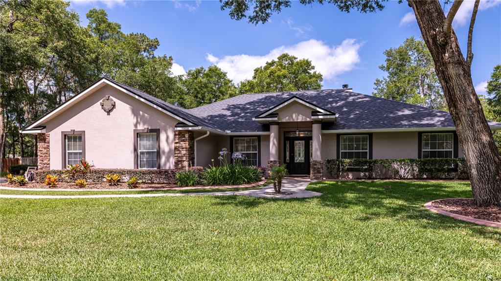 4930 Southeast 44th Circle Ocala, FL 34480 - Photo 1 of 1 a front view of a house with garden