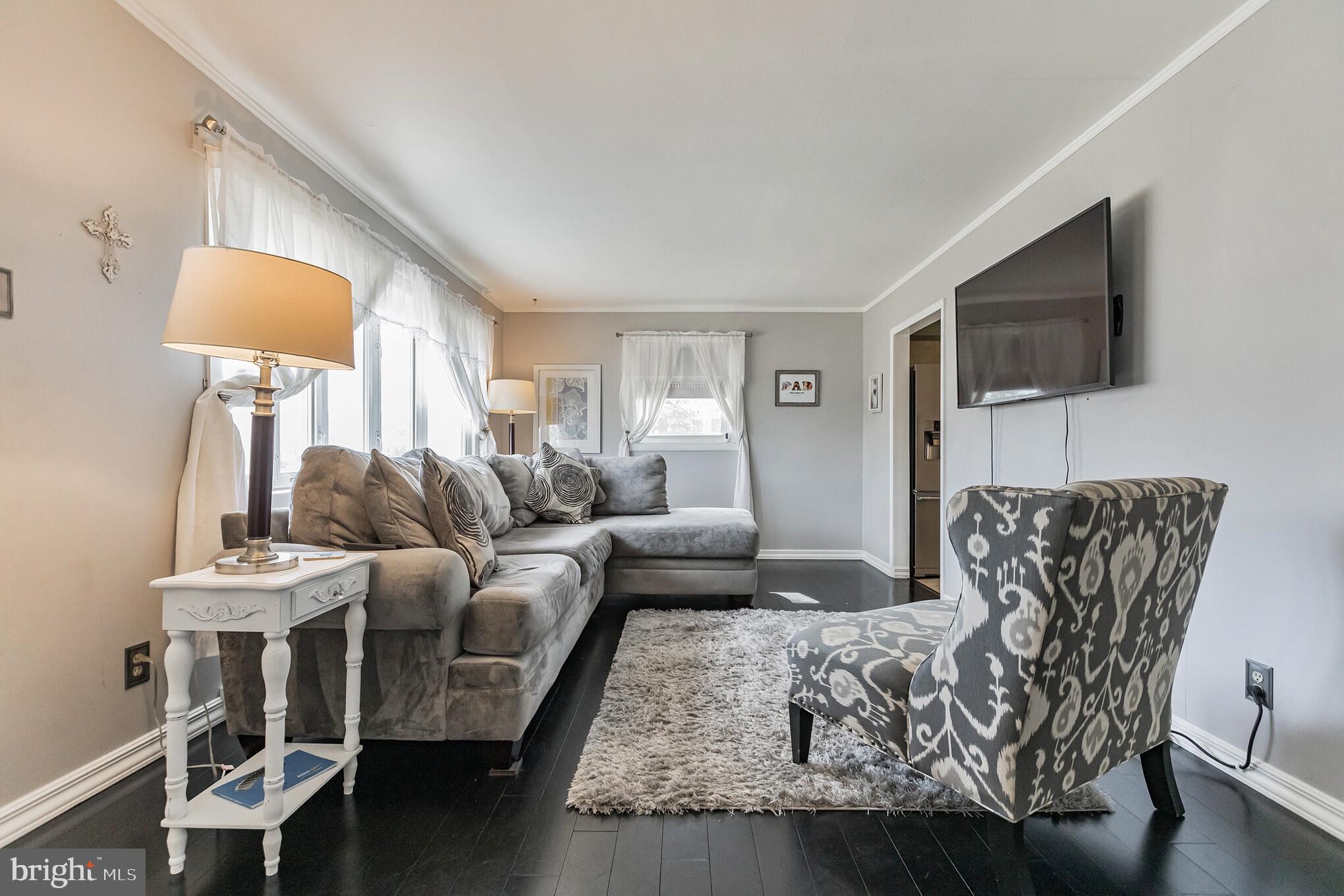 27 Boswell Road Marlton, NJ 08053 - Photo 12 of 40 a living room with furniture a flat screen tv and a lamp