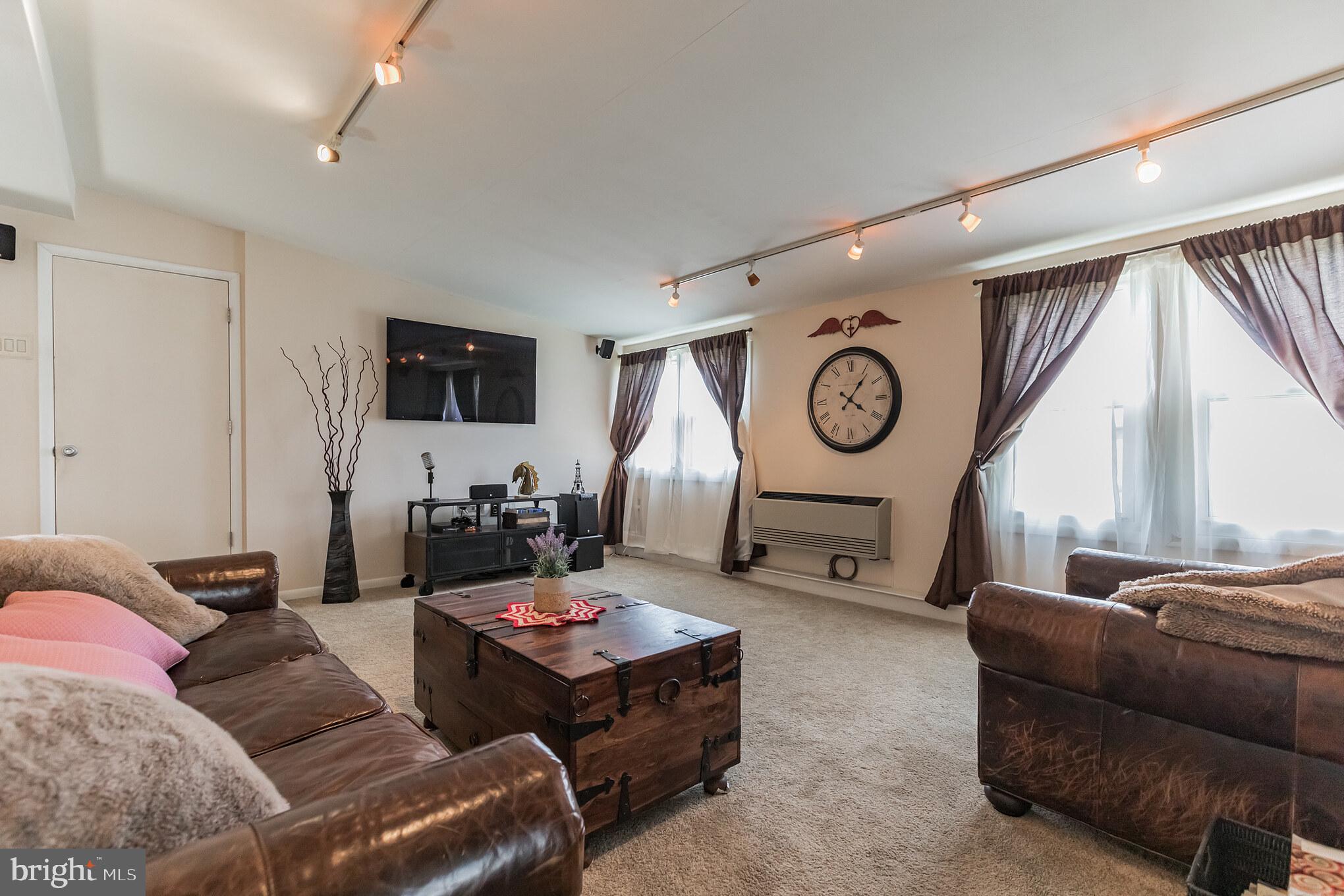 27 Boswell Road Marlton, NJ 08053 - Photo 31 of 40 a living room with furniture a large window and a clock