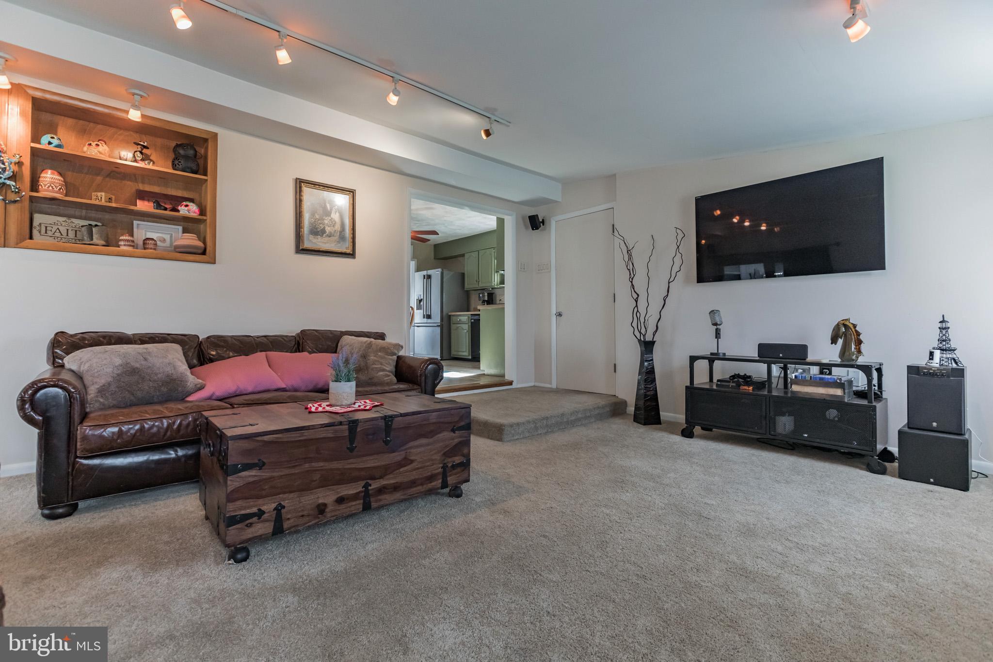 27 Boswell Road Marlton, NJ 08053 - Photo 32 of 40 a living room with furniture and a flat screen tv