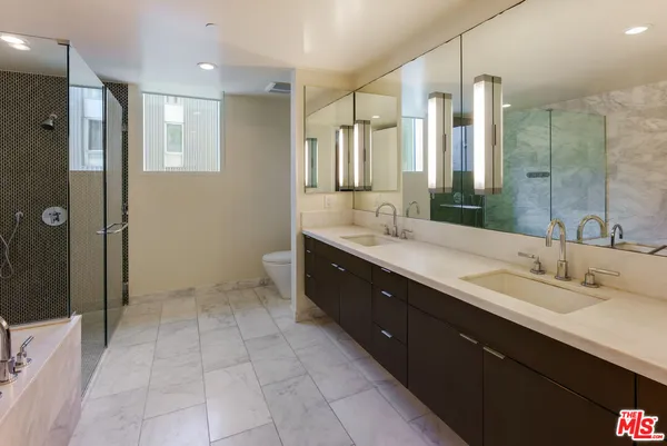 a spacious bathroom with a double vanity sink mirror and double