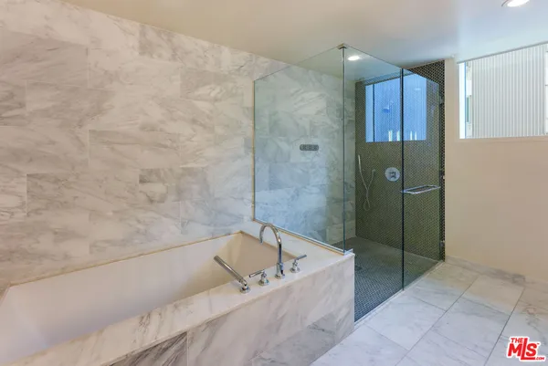a bathroom with a bathtub and shower