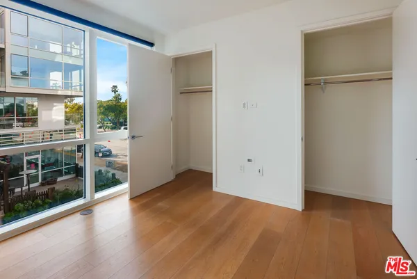 a view of a room with wooden floor and a window