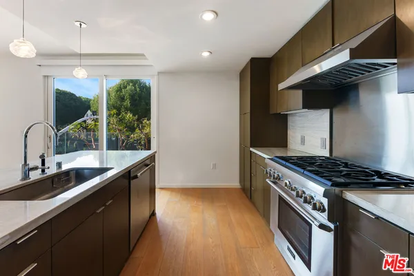 a kitchen with granite countertop a stove and a sink