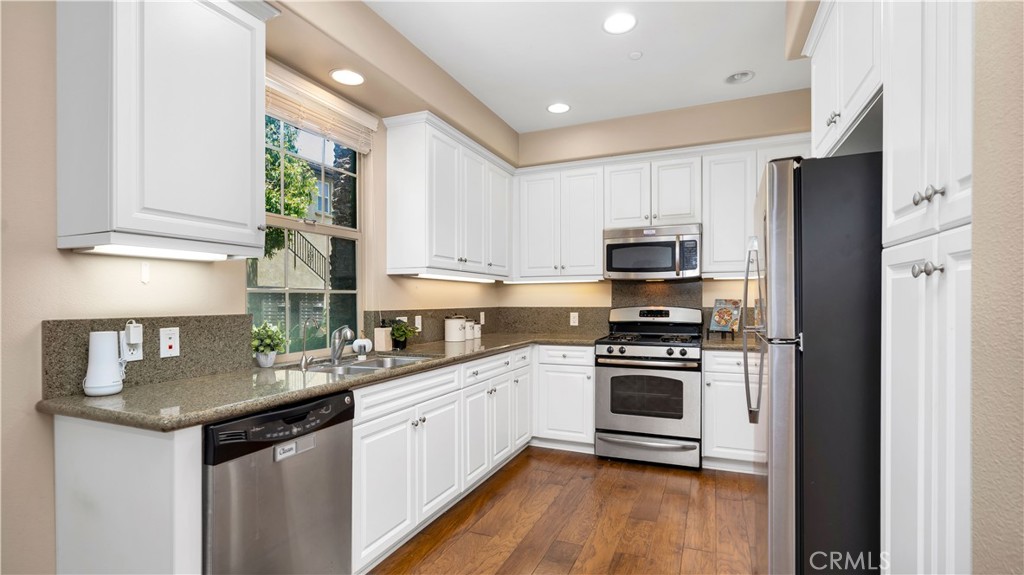 66 Full Moon Irvine, CA 92618 - Photo 17 of 32 a kitchen with a sink stove and microwave