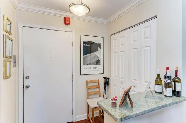 a view of hallway with furniture and wooden floor