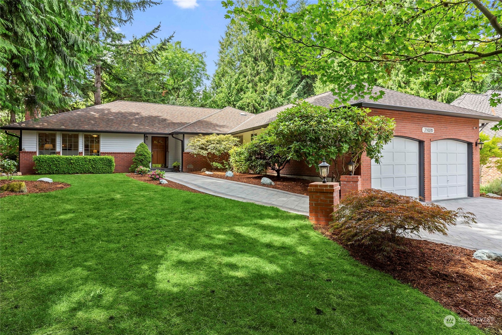 21020 49th Avenue Southeast Bothell, WA 98021 - Photo 1 of 39 a front view of a house with a garden