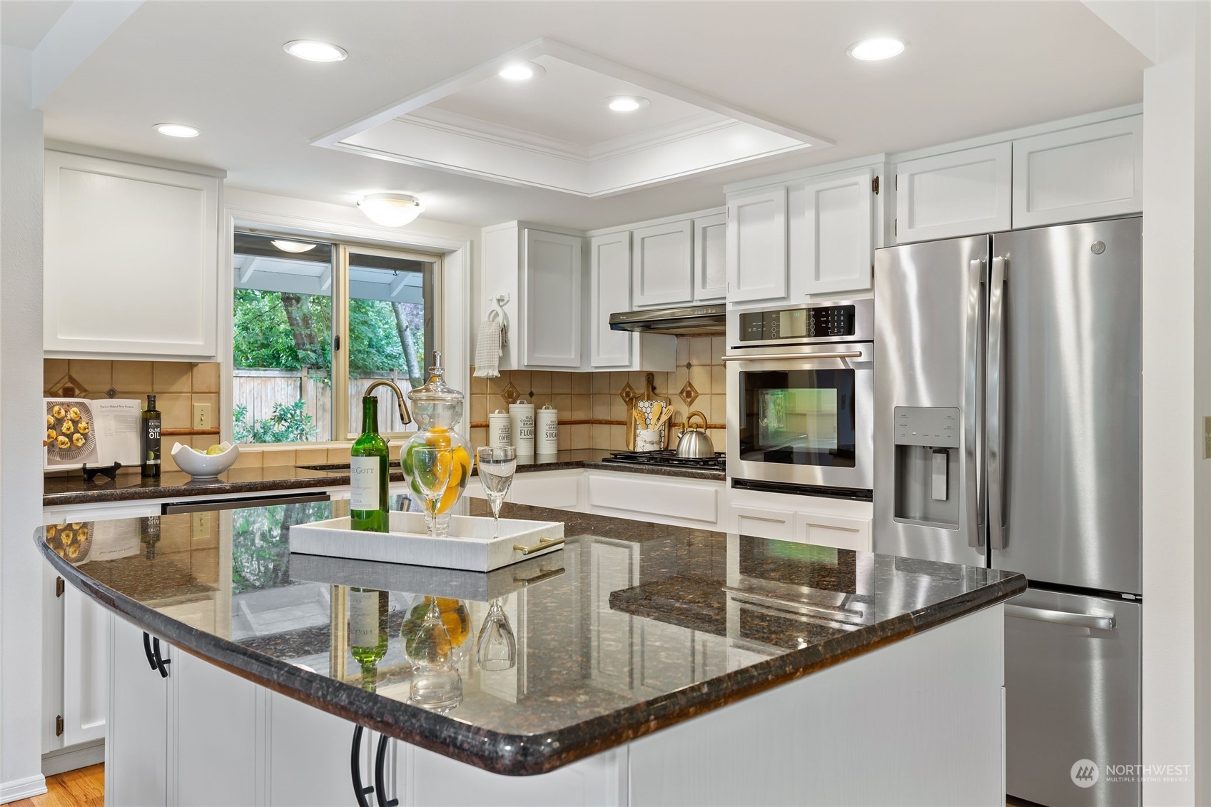 21020 49th Avenue Southeast Bothell, WA 98021 - Photo 11 of 39 a kitchen with stainless steel appliances granite countertop a sink a stove and a refrigerator
